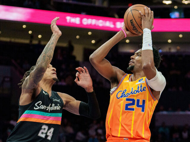 CHARLOTTE, NORTH CAROLINA - JANUARY 31: Brandon Miller #24 of the Charlotte Hornets shoots the ball over Devin Vassell #24 of the San Antonio Spurs in the first half at Spectrum Center on January 31, 2026 in Charlotte, North Carolina.