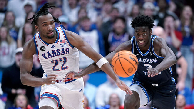 LAWRENCE, KANSAS - JANUARY 31: Darryn Peterson #22 of the Kansas Jayhawks and forward AJ Dybantsa #3 of the BYU Cougars chase down a loose ball in the first half at Allen Fieldhouse on January 31, 2026 in Lawrence, Kansas.