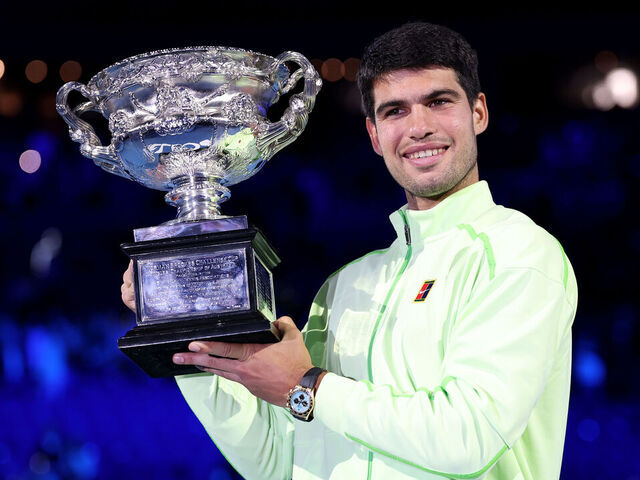 MELBOURNE, AUSTRALIA - FEBRUARY 01: Carlos Alcaraz of Spain poses with the Norman Brookes Challenge Cup at the presentation ceremony after his victory in the Men's Singles Final against Novak Djokovic of Serbia during day 15 of the 2026 Australian Open at Melbourne Park on February 01, 2026 in Melbourne, Australia.