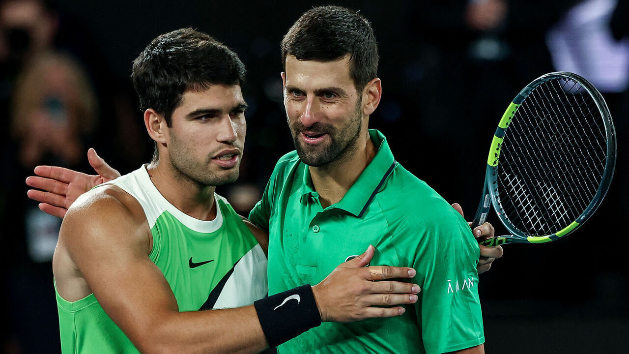 Spain's Carlos Alcaraz (L) greets Serbia's Novak Djokovic after winning their men's singles final match on day fifteen of the Australian Open tennis tournament in Melbourne on February 1, 2026. / -- IMAGE RESTRICTED TO EDITORIAL USE - STRICTLY NO COMMERCIAL USE --