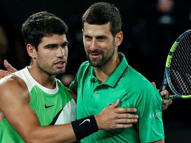 Spain's Carlos Alcaraz (L) greets Serbia's Novak Djokovic after winning their men's singles final match on day fifteen of the Australian Open tennis tournament in Melbourne on February 1, 2026. / -- IMAGE RESTRICTED TO EDITORIAL USE - STRICTLY NO COMMERCIAL USE --