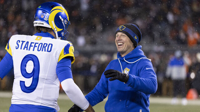 CHICAGO, ILLINOIS - JANUARY 18: Offensive Coordinator Mike LaFleur interacts with Matthew Stafford #9 of the Los Angeles Rams prior to the NFL divisional playoff football game at Soldier Field on January 18, 2026 in Chicago, Illinois.