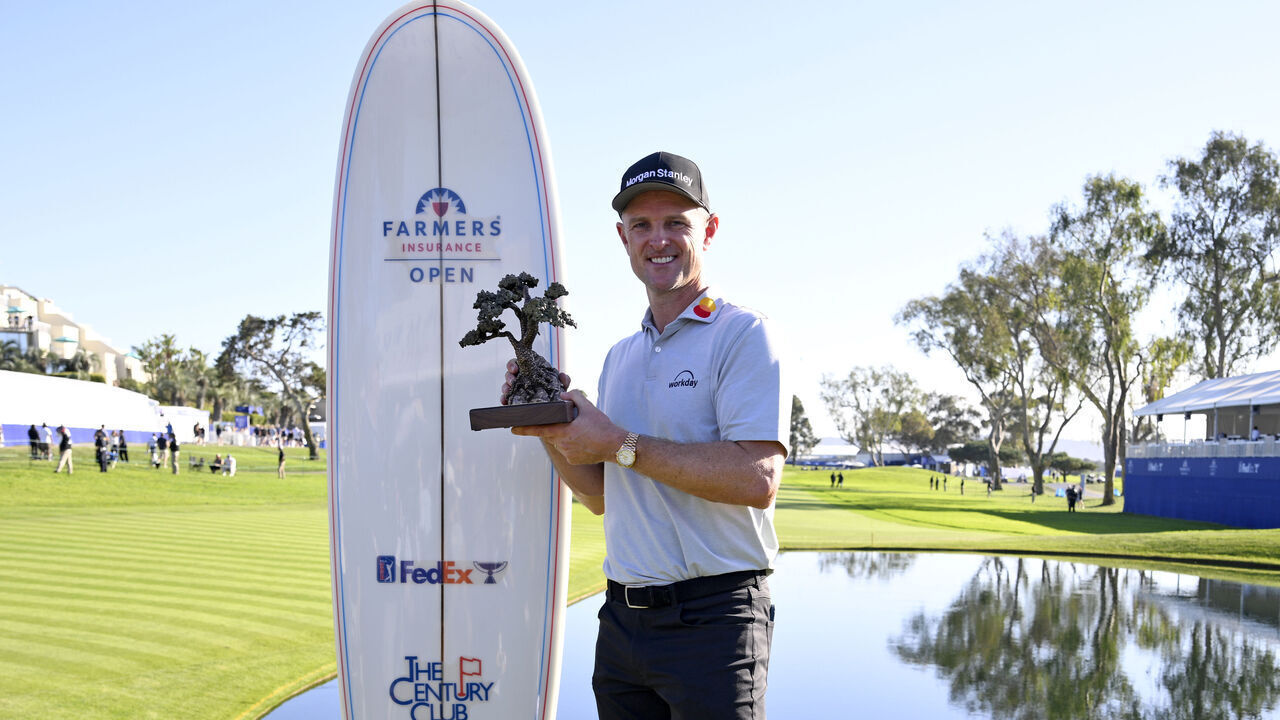 LA JOLLA, CALIFORNIA - FEBRUARY 01: Justin Rose of England poses with the trophy after putting in to win on the 18th green during the final round of the Farmers Insurance Open 2026 at Torrey Pines South Course on February 01, 2026 in La Jolla, California.