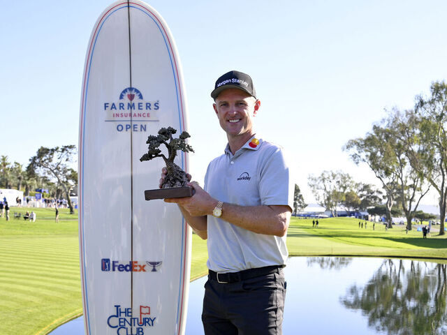 LA JOLLA, CALIFORNIA - FEBRUARY 01: Justin Rose of England poses with the trophy after putting in to win on the 18th green during the final round of the Farmers Insurance Open 2026 at Torrey Pines South Course on February 01, 2026 in La Jolla, California.