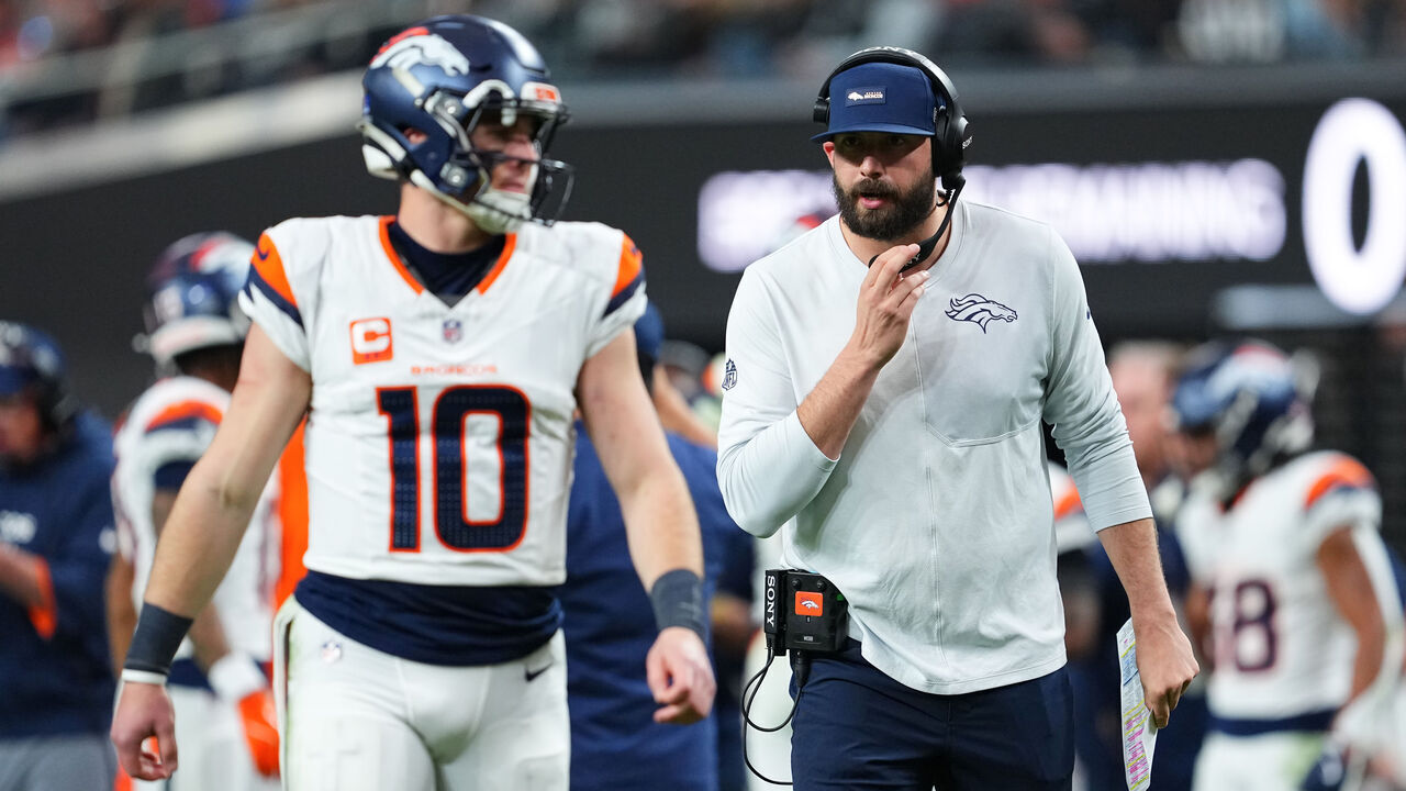 LAS VEGAS, NEVADA - DECEMBER 07: Offensive pass game coordinator and quarterbacks coach Davis Webb speaks to Bo Nix #10 of the Denver Broncos during the second half of a game at Allegiant Stadium on December 07, 2025 in Las Vegas, Nevada.