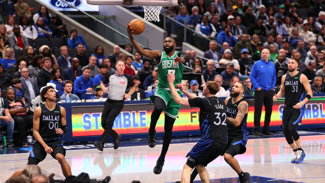DALLAS, TEXAS - FEBRUARY 03: Jaylen Brown #7 of the Boston Celtics makes a move to the basket against Cooper Flagg #32 of the Dallas Mavericks during the fourth quarter at American Airlines Center on February 03, 2026 in Dallas, Texas.