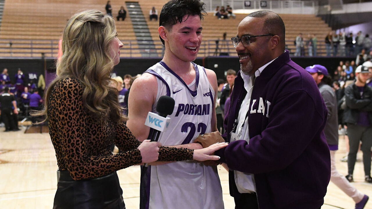 PORTLAND, OR - FEBRUARY 04: University of Portland President, Robert D. Kelly, (right) congratulates Portland Pilots guard Joel Foxwell (23) after the Pilots upset the Zags 87-80 during a college basketball game between the Portland Pilots and Gonzaga Bulldogs on February 4, 2026 at Chiles Center in Portland, Oregon.