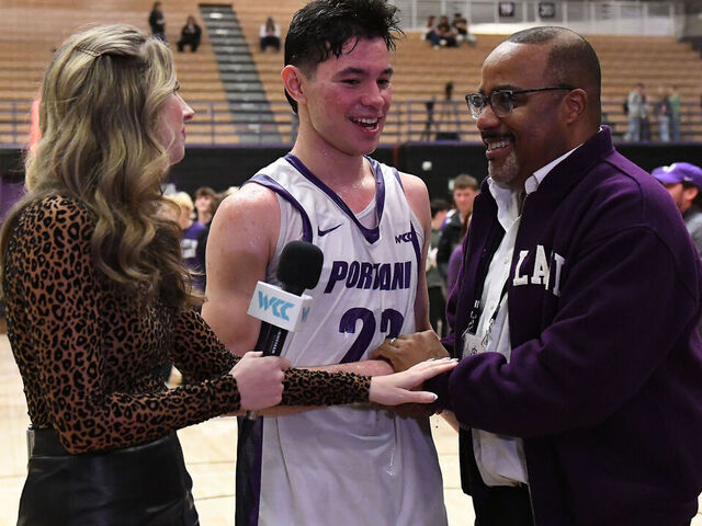 PORTLAND, OR - FEBRUARY 04: University of Portland President, Robert D. Kelly, (right) congratulates Portland Pilots guard Joel Foxwell (23) after the Pilots upset the Zags 87-80 during a college basketball game between the Portland Pilots and Gonzaga Bulldogs on February 4, 2026 at Chiles Center in Portland, Oregon.