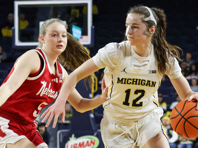 ANN ARBOR, MI - FEBRUARY 04: Michigan Wolverines guard Syla Swords (12) drives to the basket against Nebraska Cornhuskers guard Claire Johnson (5) during the first quarter of a regular season Big Ten Conference college women's basketball game between the Nebraska Cornhuskers and the Michigan Wolverines on February 4, 2026 at Crisler Center in Ann Arbor, Michigan.