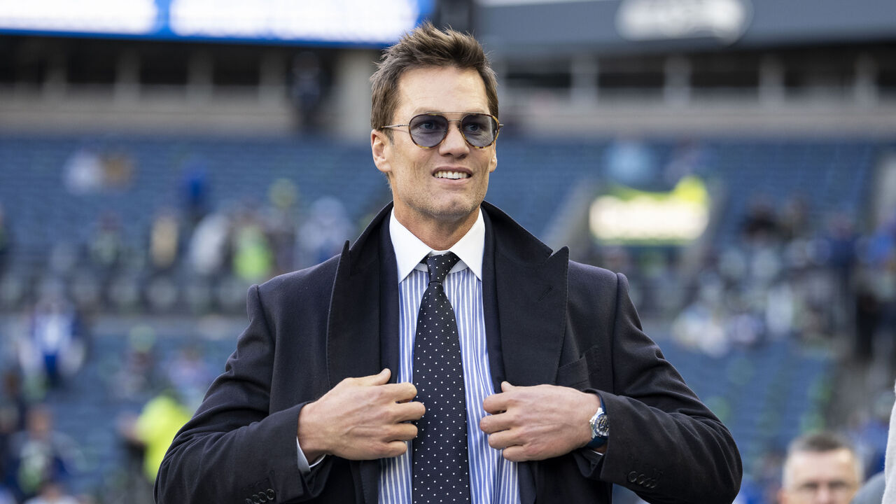 SEATTLE, WASHINGTON - JANUARY 25: Fox Sports commentator and former NFL quarterback Tom Brady reacts as he walks on to the field prior to an NFC Championship NFL football game between the Los Angeles Rams and Seattle Seahawks at Lumen Field on January 25, 2026 in Seattle, Washington.