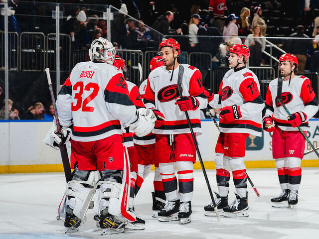 NEW YORK, NEW YORK - FEBRUARY 5: Brandon Bussi #32 and K'andre Miller #19 of the Carolina Hurricanes celebrate after the game against the New York Rangers at Madison Square Garden on February 5, 2026 in New York City.