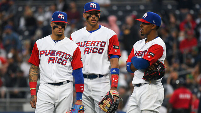 SAN DIEGO, CA - MARCH 14: Puerto Rico Second baseman Javier Baez, Puerto Rico Third baseman Carlos Correa and Puerto Rico Shortstop Francisco Lindor look on during an instant replay during the second inning of a World Baseball Classic second round Pool F game against Dominican Republic on Tuesday, March 14, 2017 at Petco Park in San Diego, CA.