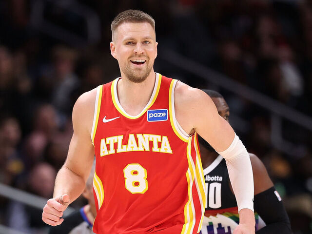 ATLANTA, GEORGIA - DECEMBER 05: Kristaps Porzingis #8 of the Atlanta Hawks reacts after hitting a three-point basket against Tim Hardaway Jr. #10 of the Denver Nuggets during the third quarter at State Farm Arena on December 05, 2025 in Atlanta, Georgia.