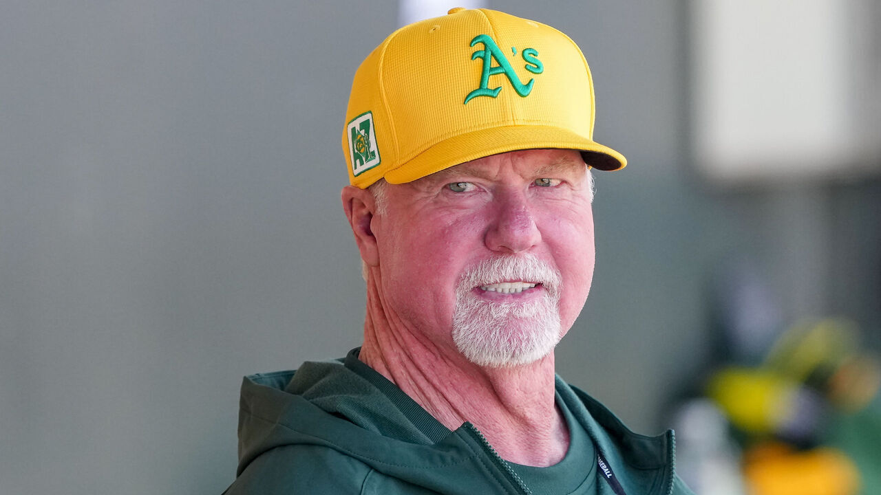 MESA, ARIZONA - MARCH 15: Mark McGwire looks on from the dugout before the game against the Texas Rangers during a spring training game at HoHoKam Stadium on March 15, 2025 in Mesa, Arizona.