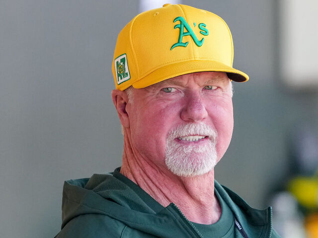 MESA, ARIZONA - MARCH 15: Mark McGwire looks on from the dugout before the game against the Texas Rangers during a spring training game at HoHoKam Stadium on March 15, 2025 in Mesa, Arizona.