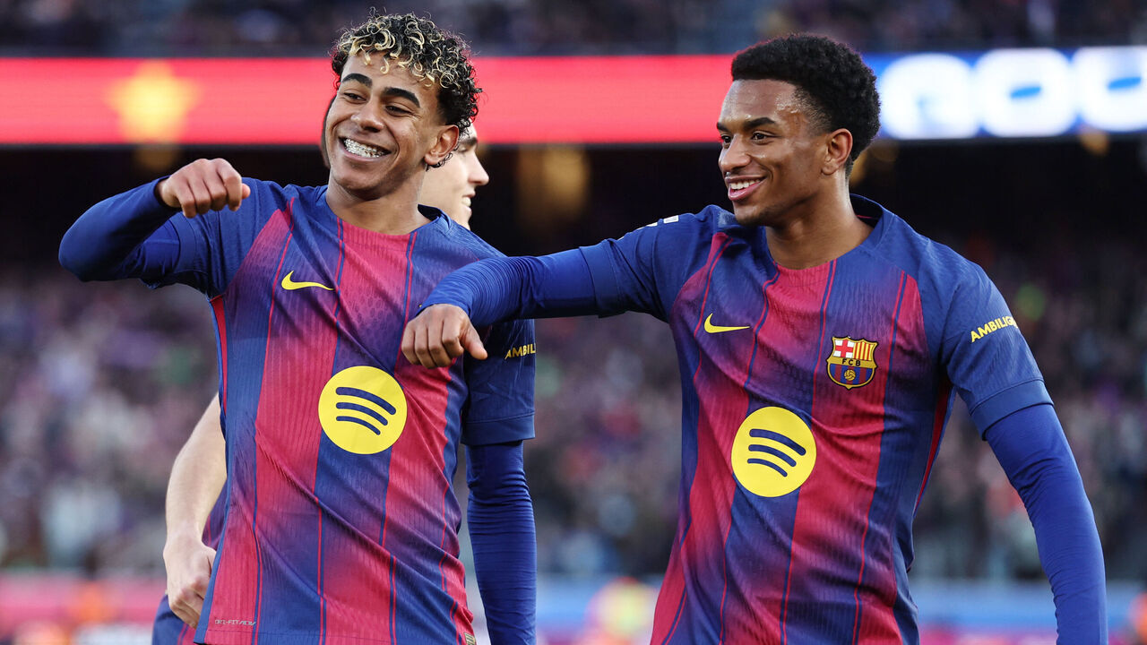 TOPSHOT - Barcelona's Spanish forward #10 Lamine Yamal celebrates scoring his team's second goal with Barcelona's Spanish defender #03 Alex Balde (R) during the Spanish league football match between FC Barcelona and RCD Mallorca at Camp Nou Stadium in Barcelona on February 7, 2026.