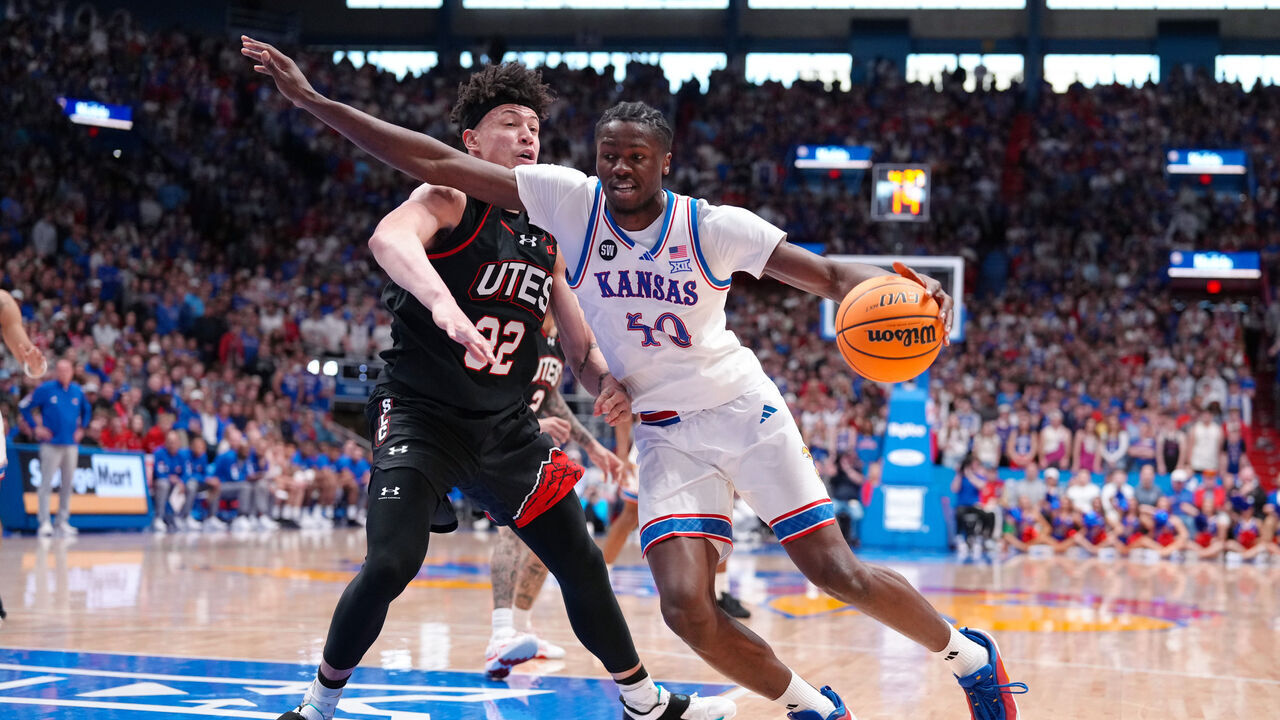 LAWRENCE, KANSAS - FEBRUARY 07: Forward Flory Bidunga #40 of the Kansas Jayhawks drives against forward James Okonkwo #32 of the Utah Utes at Allen Fieldhouse on February 07, 2026 in Lawrence, Kansas.