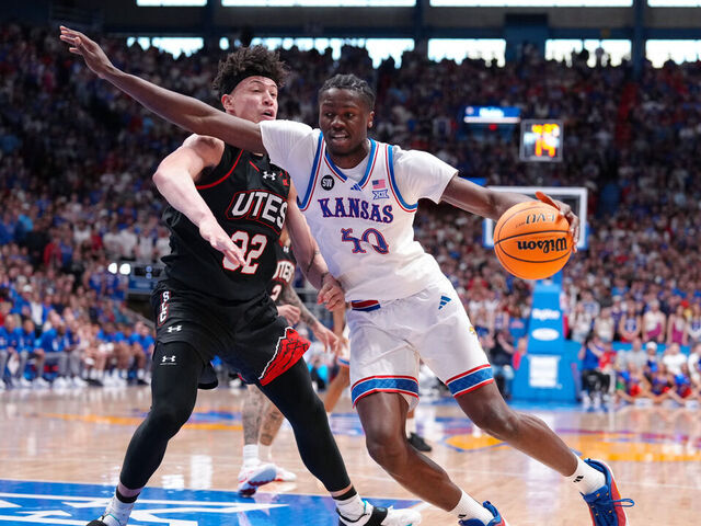 LAWRENCE, KANSAS - FEBRUARY 07: Forward Flory Bidunga #40 of the Kansas Jayhawks drives against forward James Okonkwo #32 of the Utah Utes at Allen Fieldhouse on February 07, 2026 in Lawrence, Kansas.