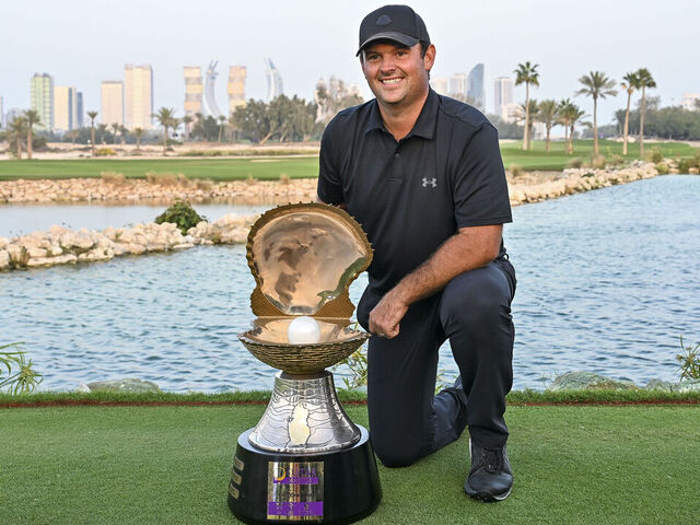 Patrick Reed of the United States celebrates with the trophy following his victory on day four of the Qatar Masters 2026 golf tournament at the Doha Golf Club in Doha, Qatar, on February 8, 2026.