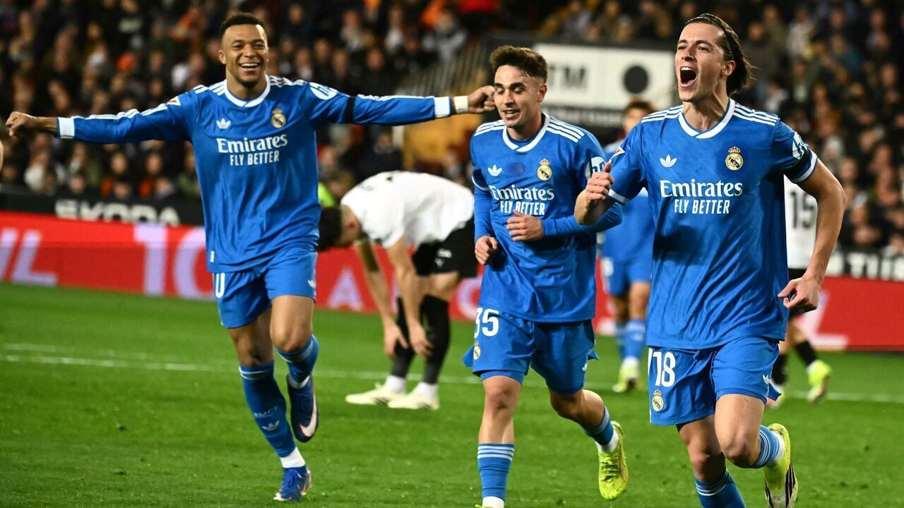 Real Madrid's Spanish defender #18 Alvaro Carreras celebrates with Real Madrid's French forward #10 Kylian Mbappe (L) scoring his team's first goal during the Spanish league football match between Valencia CF and Real Madrid CF at Mestalla Stadium in Valencia on February 8, 2026.