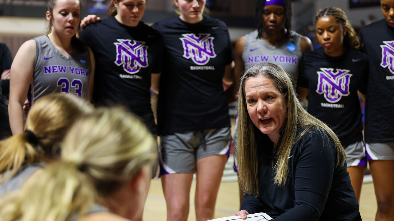 SALEM, VIRGINIA - MARCH 22: Head coach Meg Barber of the NYU Violets instructs her team in the second half during the Division III Women's Basketball Championship held at the Cregger Center on March 22, 2025 in Salem, Virginia.