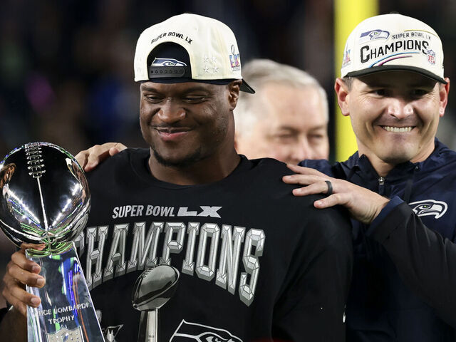 SANTA CLARA, CALIFORNIA - FEBRUARY 08: Mike MacDonald of the Seattle Seahawks and Kenneth Walker III #9 of the Seattle Seahawks celebrate with the Vince Lombardi Trophy after defeating the New England Patriots in the Super Bowl LX at Levi's Stadium on February 08, 2026 in Santa Clara, California.