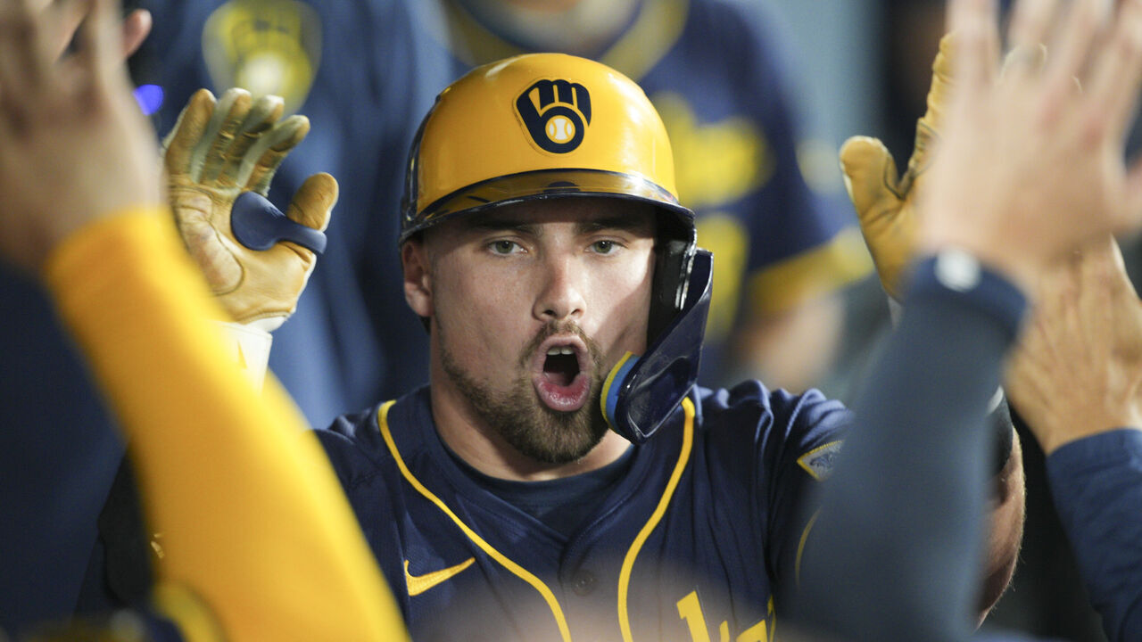 LOS ANGELES, CA - JULY 18: Caleb Durbin #21 of the Milwaukee Brewers celebrates in the dugout during the game between the Milwaukee Brewers and the Los Angeles Dodgers at Dodger Stadium on Friday, July 18, 2025 in Los Angeles, California.