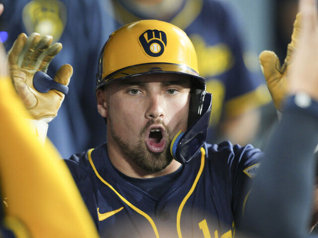 LOS ANGELES, CA - JULY 18: Caleb Durbin #21 of the Milwaukee Brewers celebrates in the dugout during the game between the Milwaukee Brewers and the Los Angeles Dodgers at Dodger Stadium on Friday, July 18, 2025 in Los Angeles, California.