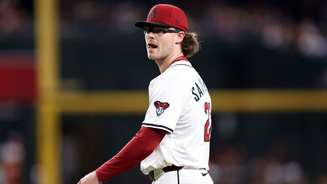 PHOENIX, ARIZONA - SEPTEMBER 16: Relief pitcher Andrew Saalfrank #27 of the Arizona Diamondbacks walks off the field after the final out against the San Francisco Giants in the ninth inning at Chase Field on September 16, 2025 in Phoenix, Arizona.