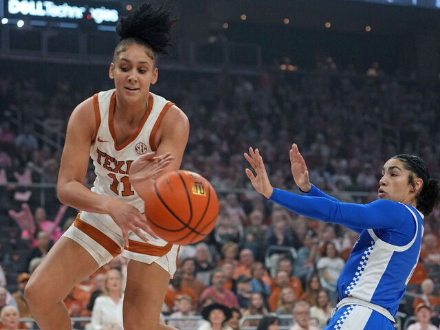 AUSTIN, TEXAS - FEBRUARY 9: Justice Carlton #11 of the Texas Longhorns attempts to save the ball from going out of bounds ahead of Asia Boone #8 of the Kentucky Wildcats during the first half at Moody Center on February 9, 2026 in Austin, Texas.