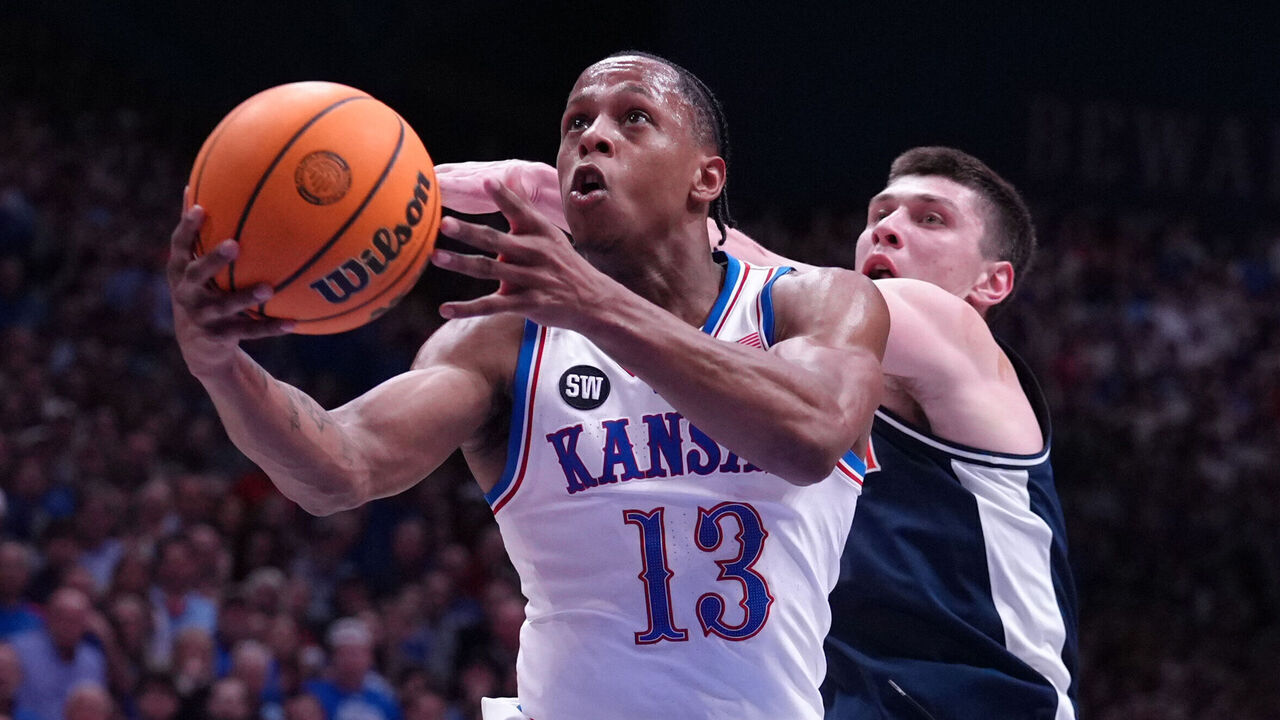 LAWRENCE, KANSAS - FEBRUARY 09: Guard Elmarko Jackson #13 of the Kansas Jayhawks goes up for a shot against forward Ivan Kharchenkov #8 of the Arizona Wildcats in the first half at Allen Fieldhouse on February 09, 2026 in Lawrence, Kansas.