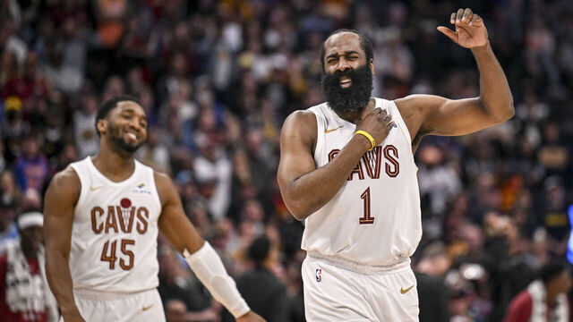 DENVER , CO - FEBRUARY 9: James Harden (1) of the Cleveland Cavaliers stretches his shoulder after hitting a clutch three pointer as Donovan Mitchell (45) smiles during the fourth quarter of the Cavs' 119-117 win over the Denver Nuggets at Ball Arena in Denver, Colorado on Monday, February 9, 2026.