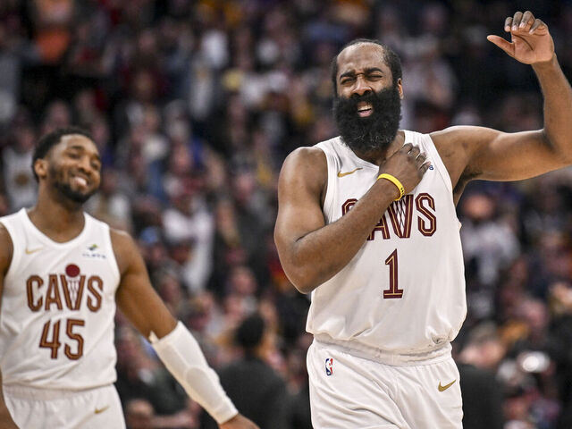 DENVER , CO - FEBRUARY 9: James Harden (1) of the Cleveland Cavaliers stretches his shoulder after hitting a clutch three pointer as Donovan Mitchell (45) smiles during the fourth quarter of the Cavs' 119-117 win over the Denver Nuggets at Ball Arena in Denver, Colorado on Monday, February 9, 2026.