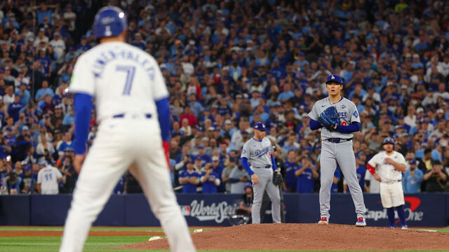TORONTO, ONTARIO - NOVEMBER 01: Pitcher Yoshinobu Yamamoto #18 of the Los Angeles Dodgers checks shortstop Isiah Kiner-Falefa #7 of the Toronto Blue Jays on third base during the 9th inning of game seven of the 2025 World Series at Rogers Center on November 01, 2025 in Toronto, Ontario.