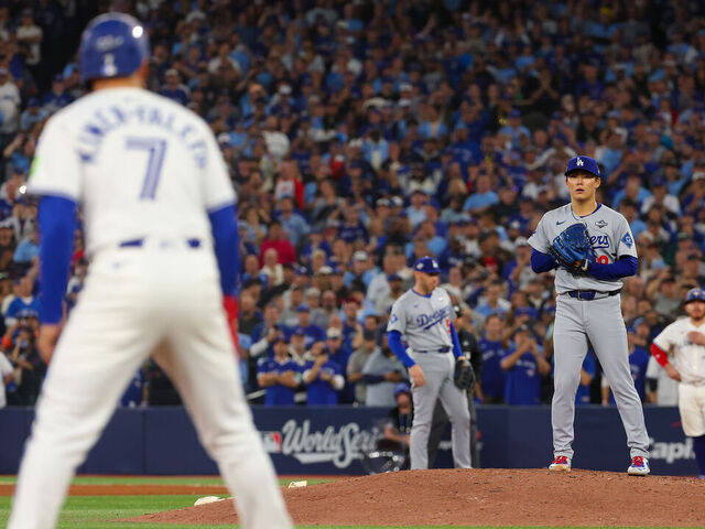 TORONTO, ONTARIO - NOVEMBER 01: Pitcher Yoshinobu Yamamoto #18 of the Los Angeles Dodgers checks shortstop Isiah Kiner-Falefa #7 of the Toronto Blue Jays on third base during the 9th inning of game seven of the 2025 World Series at Rogers Center on November 01, 2025 in Toronto, Ontario.