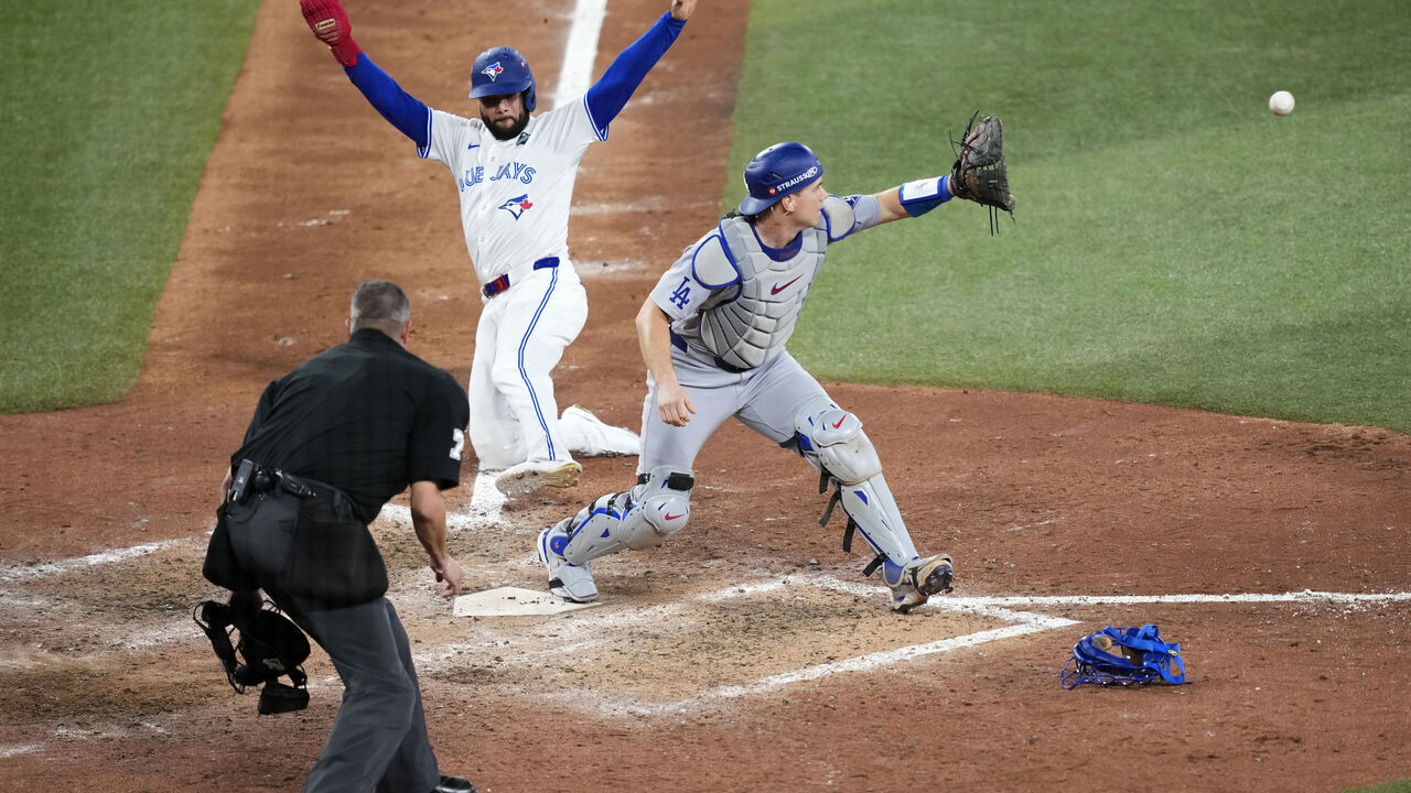 TORONTO, ONTARIO - NOVEMBER 01: Will Smith #16 of the Los Angeles Dodgers forces Isiah Kiner-Falefa #7 of the Toronto Blue Jays out at home plate for the second out during the ninth inning in game seven of the 2025 World Series at Rogers Center on November 01, 2025 in Toronto, Ontario.