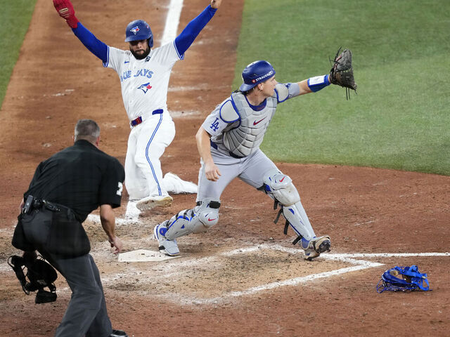 TORONTO, ONTARIO - NOVEMBER 01: Will Smith #16 of the Los Angeles Dodgers forces Isiah Kiner-Falefa #7 of the Toronto Blue Jays out at home plate for the second out during the ninth inning in game seven of the 2025 World Series at Rogers Center on November 01, 2025 in Toronto, Ontario.