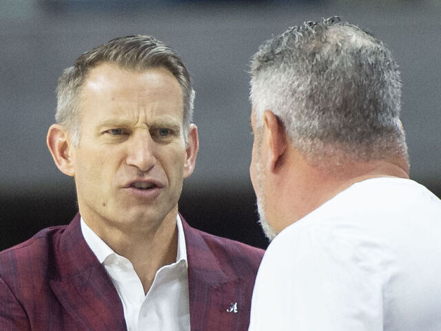AUBURN, ALABAMA - FEBRUARY 11: Head coach Nate Oats of the Alabama Crimson Tide speaks to head coach Bruce Pearl of the Auburn Tigers prior to their game at Neville Arena on February 11, 2023 in Auburn, Alabama.