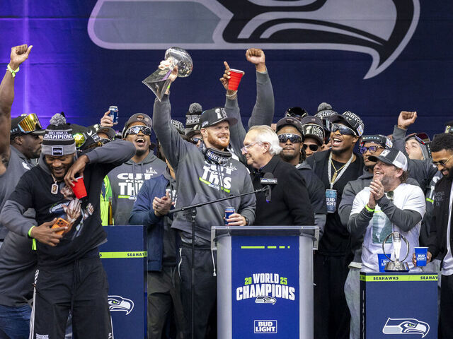Sam Darnold of the Seattle Seahawks holds up the Vince Lombardi Trophy during a Super Bowl LX trophy celebration at Lumen Field in Seattle, Washington, on February 11, 2026.