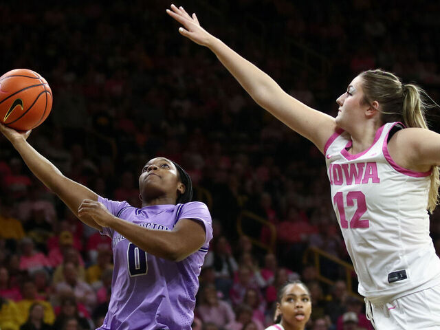 IOWA CITY, IA - FEBRUARY 11: Guard Sayvia Sellers #0 of the Washington Huskies goes to the basket in the first half against center Layla Hayes #12 of the Iowa Hawkeyes on February 11, 2026 at Carver-Hawkeye Arena, in Iowa City, Iowa.