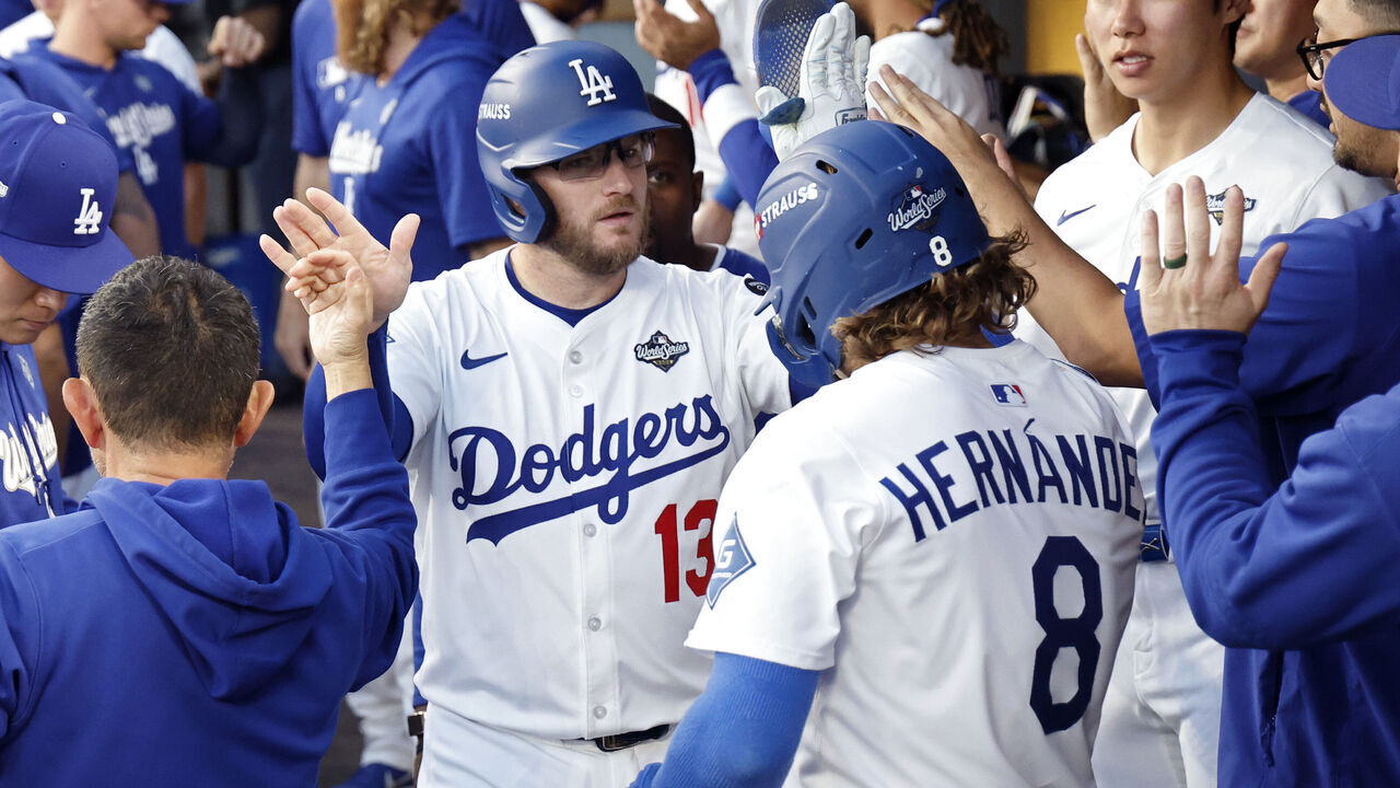 LOS ANGELES, CALIFORNIA - OCTOBER 28: Max Muncy #13 and Enrique Hernández #8 of the Los Angeles Dodgers celebrate after a sacrifice fly results in the first score of the game in the second inning against the Toronto Blue Jays in game four of the 2025 World Series at Dodger Stadium on October 28, 2025 in Los Angeles, California.