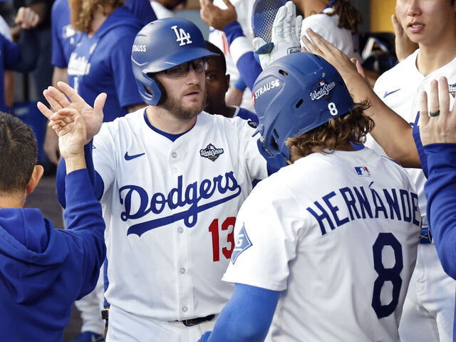 LOS ANGELES, CALIFORNIA - OCTOBER 28: Max Muncy #13 and Enrique Hernández #8 of the Los Angeles Dodgers celebrate after a sacrifice fly results in the first score of the game in the second inning against the Toronto Blue Jays in game four of the 2025 World Series at Dodger Stadium on October 28, 2025 in Los Angeles, California.