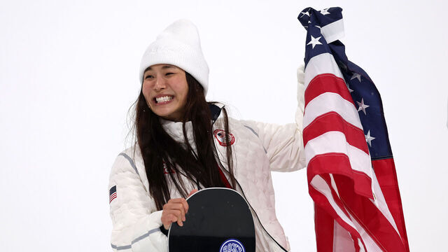 LIVIGNO, ITALY - FEBRUARY 12: Silver medalist Chloe Kim of Team United States celebrates with the national flag of the United States during the medal ceremony for the Women’s Snowboard Halfpipe on day six of the Milano Cortina 2026 Winter Olympic games at Livigno Snow Park on February 12, 2026 in Livigno, Italy.