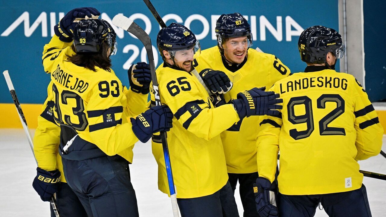 Sweden's #92 Gabriel Landeskog (R) celebrates with teammates after scoring his team first goal during the men's preliminary round Group B Ice Hockey match between Sweden and Italy at the Milano Santagiulia Ice Hockey Arena during the Milano Cortina 2026 Winter Olympic Games in Milan, on February 11, 2026.
