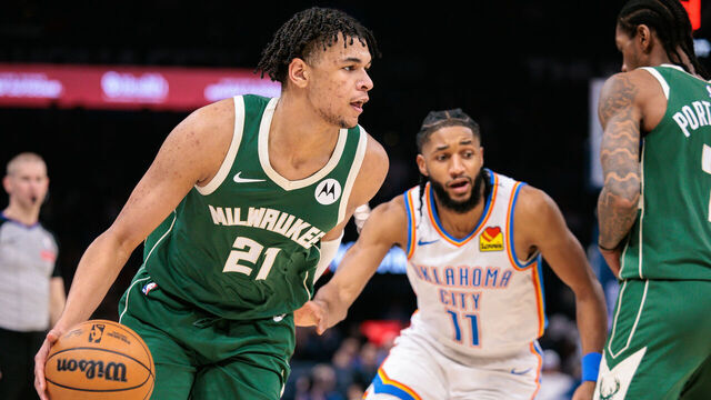 OKLAHOMA CITY, OKLAHOMA - FEBRUARY 12: Ousmane Dieng #21 of the Milwaukee Bucks drives to the basket past Isaiah Joe #11 of the Oklahoma City Thunder during the second half at Paycom Center on February 12, 2026 in Oklahoma City, Oklahoma.