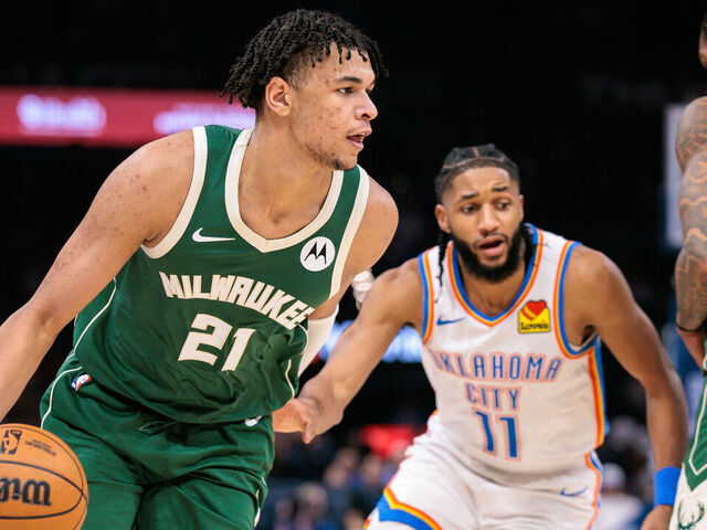 OKLAHOMA CITY, OKLAHOMA - FEBRUARY 12: Ousmane Dieng #21 of the Milwaukee Bucks drives to the basket past Isaiah Joe #11 of the Oklahoma City Thunder during the second half at Paycom Center on February 12, 2026 in Oklahoma City, Oklahoma.