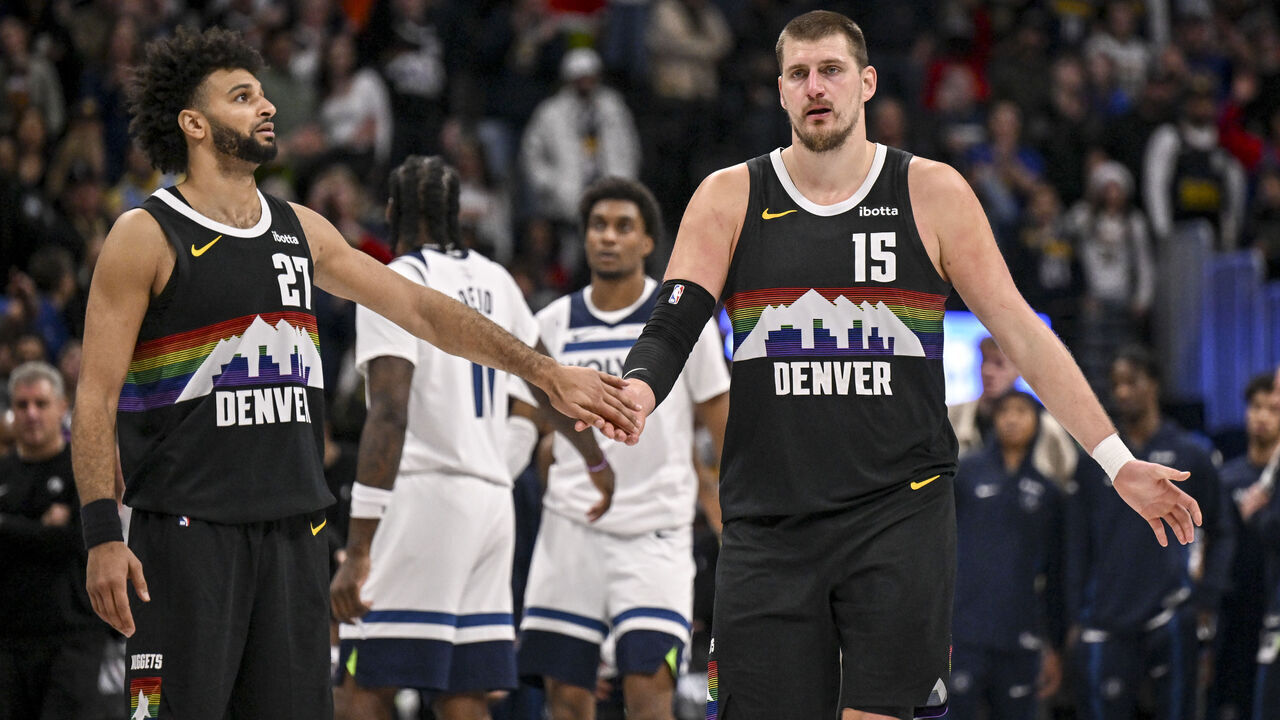 DENVER , CO - DECEMBER 26: Nikola Jokic (15) and Jamal Murray (27) of the Denver Nuggets shake hands during overtime of the Nuggets' 142-138 win over the Minnesota Timberwolves at Ball Arena in Denver, Colorado on Thursday, December 25, 2025.