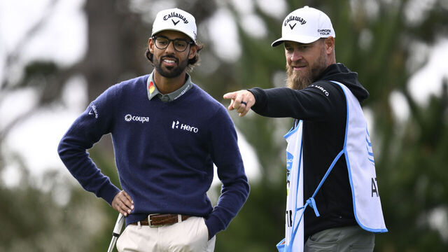 PEBBLE BEACH, CALIFORNIA - FEBRUARY 13: Akshay Bhatia of the United States and his caddie prepare to play a shot on the 18th hole during the second round of the AT&T Pebble Beach Pro-Am 2026 at Spyglass Hill Golf Course on February 13, 2026 in Pebble Beach, California.