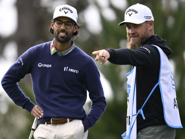 PEBBLE BEACH, CALIFORNIA - FEBRUARY 13: Akshay Bhatia of the United States and his caddie prepare to play a shot on the 18th hole during the second round of the AT&T Pebble Beach Pro-Am 2026 at Spyglass Hill Golf Course on February 13, 2026 in Pebble Beach, California.
