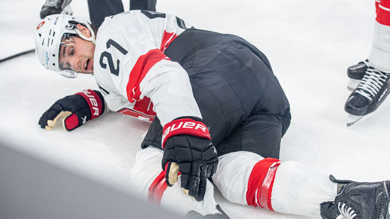 MILAN, ITALY - FEBRUARY 13: Kevin Fiala #21 of Switzerland suffers an injury during the Men's Preliminary Group A match between Canada and Switzerland on day seven of the Milano Cortina 2026 Winter Olympic games at Milano Santagiulia Ice Hockey Arena on February 13, 2026 in Milan, Italy.